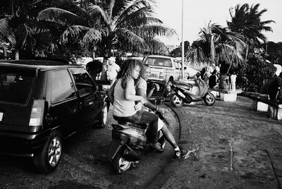 Man riding horse cart on palm trees