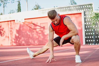 Side view of woman exercising in gym