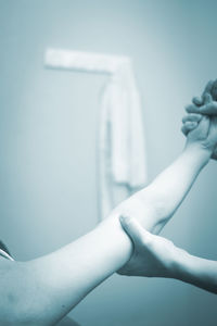 Cropped image of doctor examining hand