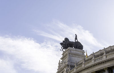 Low angle view of statue against sky