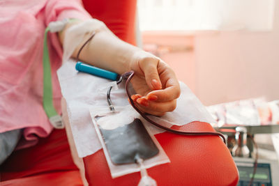 Young woman making blood donation in hospital.