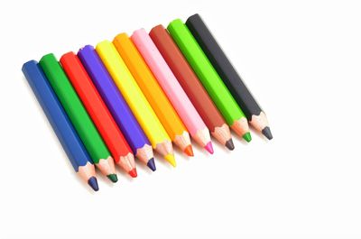 Multi colored pencils against white background