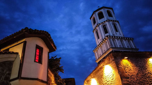 Low angle view of illuminated building against sky at night
