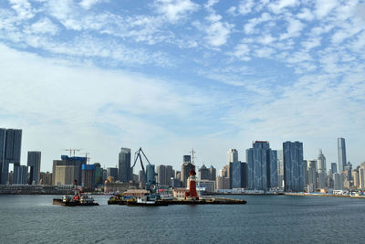 Scenic view of sea and buildings against sky