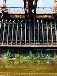 Low angle view of bridge over river against building