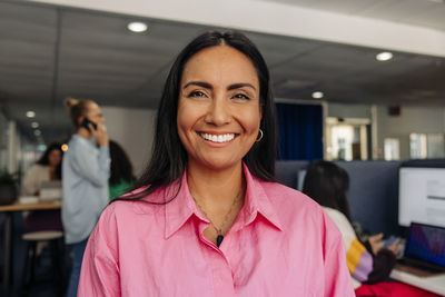 Portrait of happy female entrepreneur at office