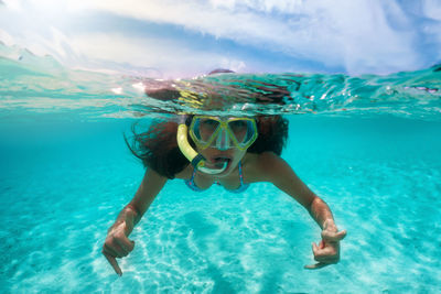 Portrait of young woman swimming in sea