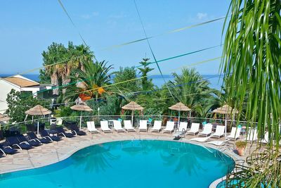 High angle view of swimming pool surrounded by lounge chairs