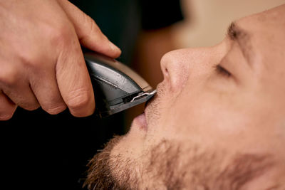 Close-up of man using mobile phone