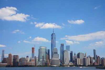 View of skyscrapers against cloudy sky