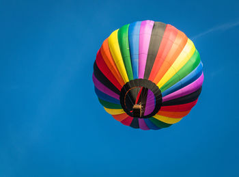 Low angle view of hot air balloon against blue sky