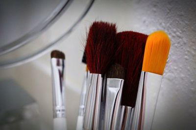 Close-up of make-up brushes on table