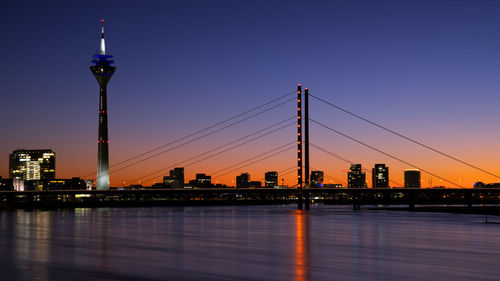 Colorful sunset on the rhine river with the cityscape of dusseldorf in the background, germany