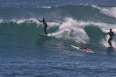 People surfing in sea