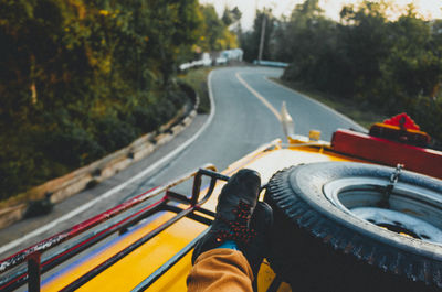 Low section of person sitting on bus