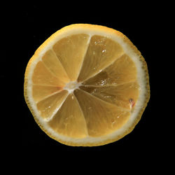 Close-up of lemon slice against black background