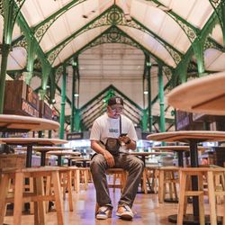 Portrait of man sitting on chair in cafe