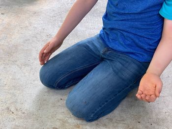 Low section of man sitting outdoors