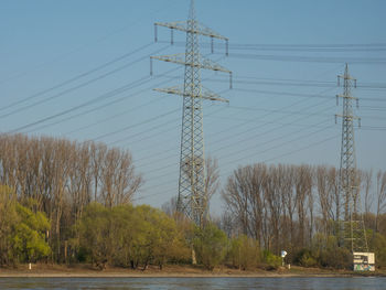 Low angle view of electricity pylon against sky