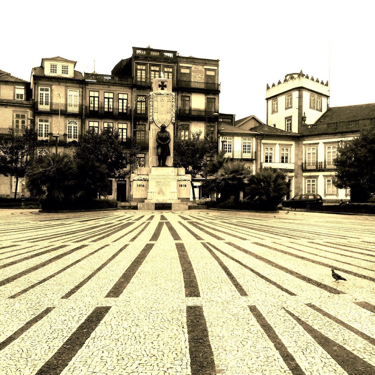 architecture, building exterior, built structure, clear sky, religion, place of worship, spirituality, facade, church, tree, day, history, city, outdoors, travel destinations, cobblestone, no people, sunlight