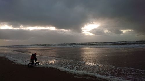 Man on beach against sky