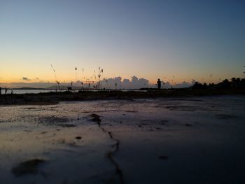 Scenic view of beach against sky during sunset