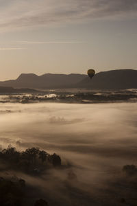 Hot air balloons against sky during sunset