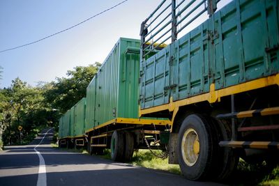 View of empty road with container truck against clear sky