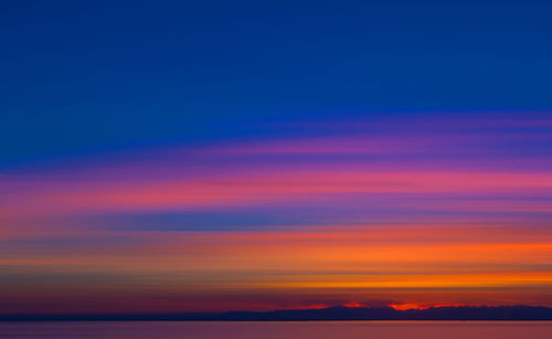 Scenic view of sea against romantic sky at sunset