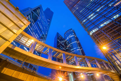 Low angle view of illuminated buildings against sky at night