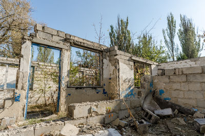 Old abandoned building against sky