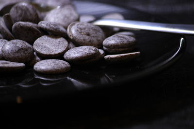 Close-up of black coffee beans on table