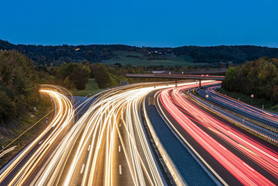 Germany, baden-wurttemberg, leonberg, vehicle light trails stretching alongbundesautobahn8 at dusk