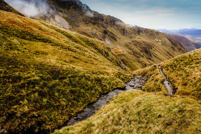 Steam amidst mountains against sky