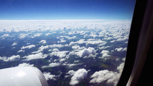 Aerial view of clouds seen through airplane window