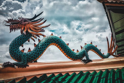 Low angle view of statue on roof