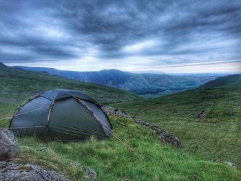 Scenic view of mountains against cloudy sky