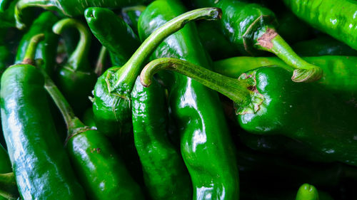 Full frame shot of green chili peppers at market