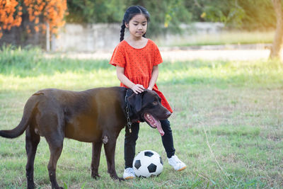 Full length of girl playing with ball