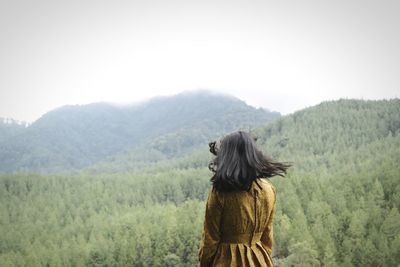 Rear view of woman looking at forest