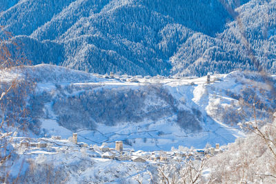 Scenic view of snowcapped mountains against blue sky