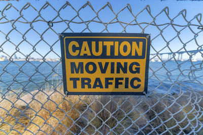 Warning sign on chainlink fence