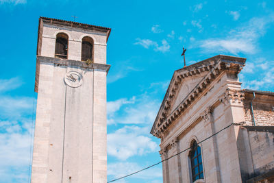 Low angle view of clock tower against sky