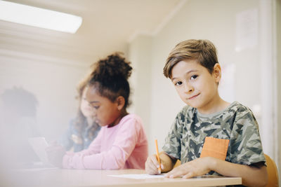 Portrait of a boy sitting on table