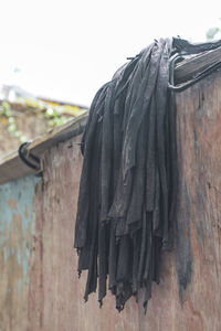 Close-up of clothes drying on roof against clear sky