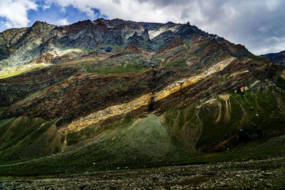 Scenic view of lake and mountains against sky and clouds