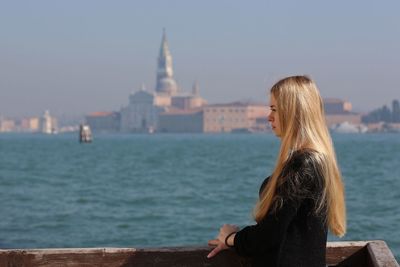 Side view of young woman by venice seaside