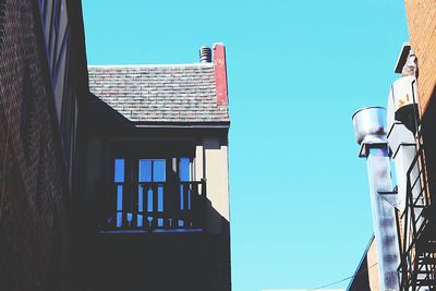 Low angle view of building against clear blue sky