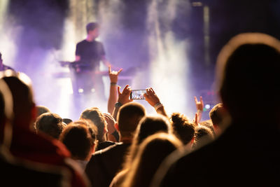 People enjoying music concert at night