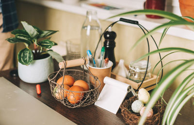 Easter day. painted eggs in basket on wooden table at kitchen. decoration